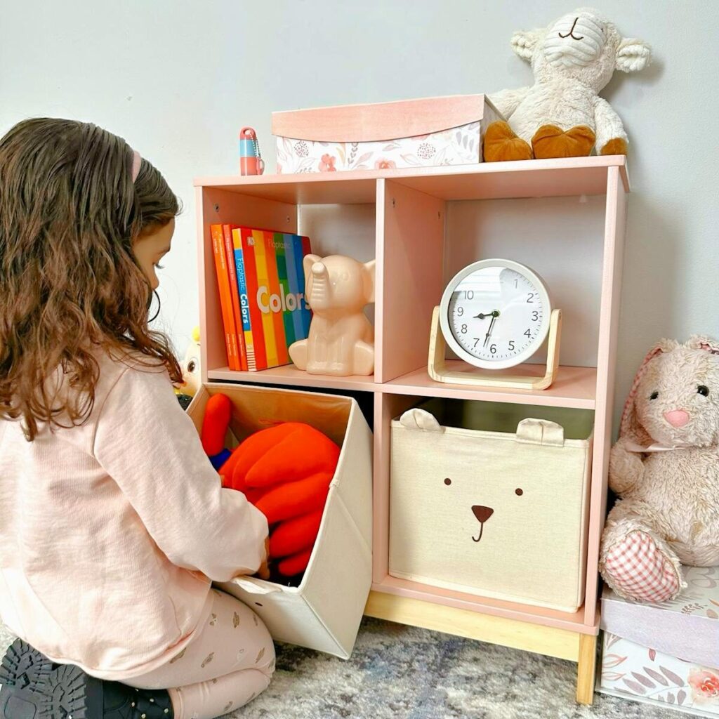A child organizes toys on a colorful shelf in a cozy nursery setting.