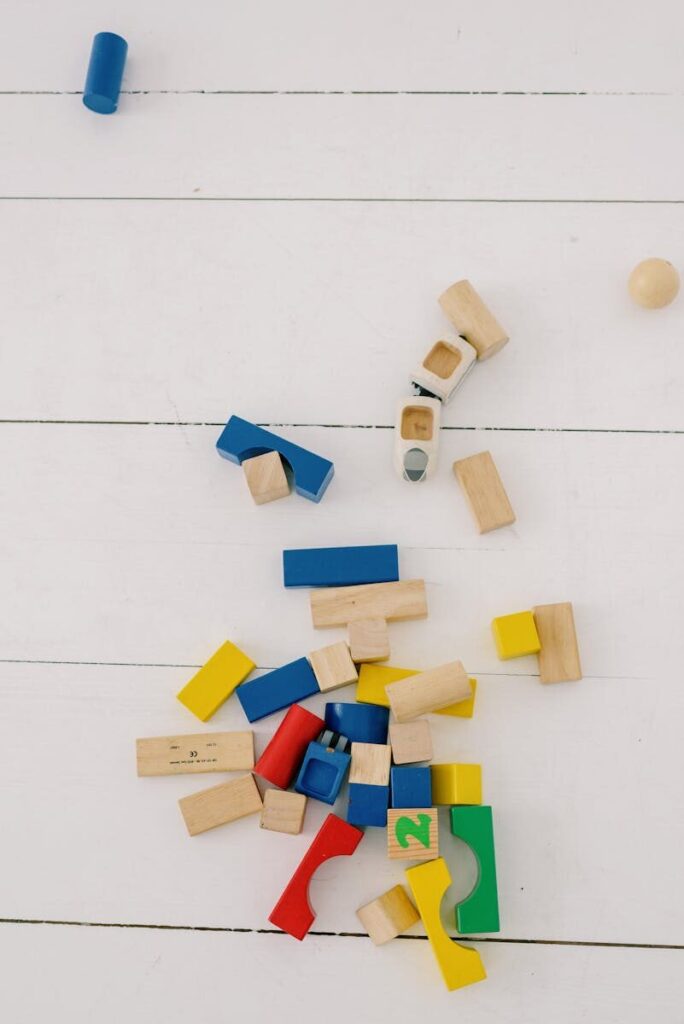 Aerial view of scattered colorful wooden blocks on a light background.